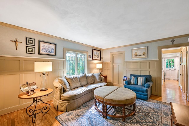 933 Juneau Dr, Fontana, WI 53125 - living room with a decorative wall, healthy amount of natural light, ornamental molding, wood finished floors, and a wainscoted wall