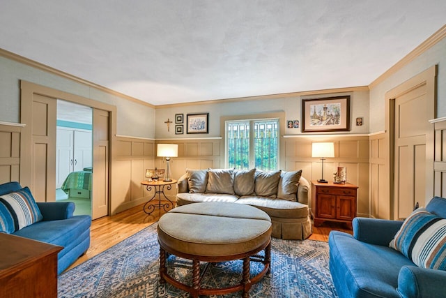 933 Juneau Dr, Fontana, WI 53125 - living area with a decorative wall, ornamental molding, wood finished floors, and a wainscoted wall