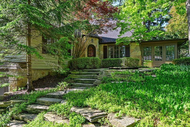 933 Juneau Dr, Fontana, WI 53125 - english style home featuring stone siding, a shingled roof, and french doors