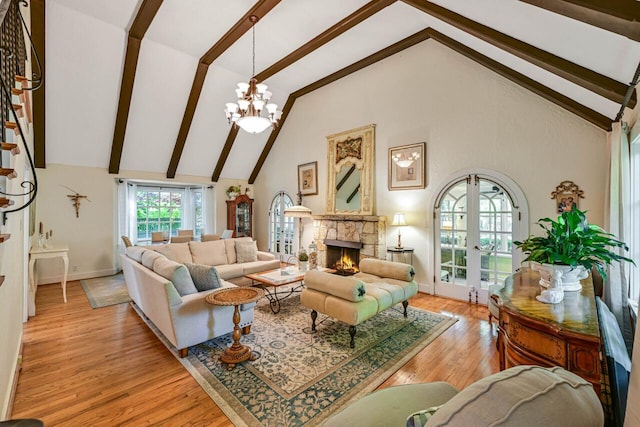 933 Juneau Dr, Fontana, WI 53125 - living area featuring high vaulted ceiling, beamed ceiling, light wood-style floors, baseboards, and a stone fireplace