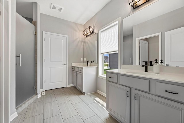 1279 E Hickory Creek Ct, Oak Creek, WI 53154 - full bath featuring a stall shower, two vanities, and baseboards