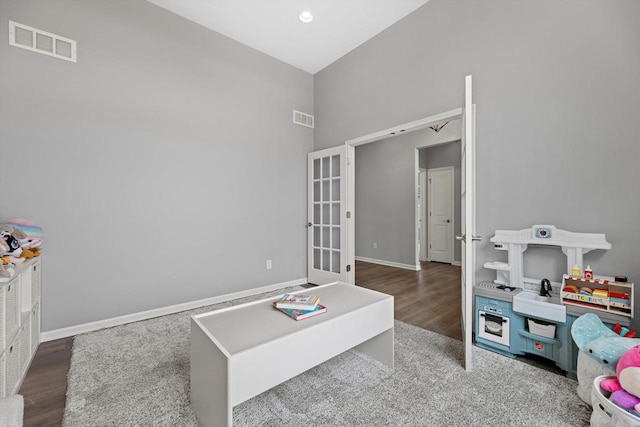 1279 E Hickory Creek Ct, Oak Creek, WI 53154 - rec room with wood finished floors, a high ceiling, baseboards, and french doors
