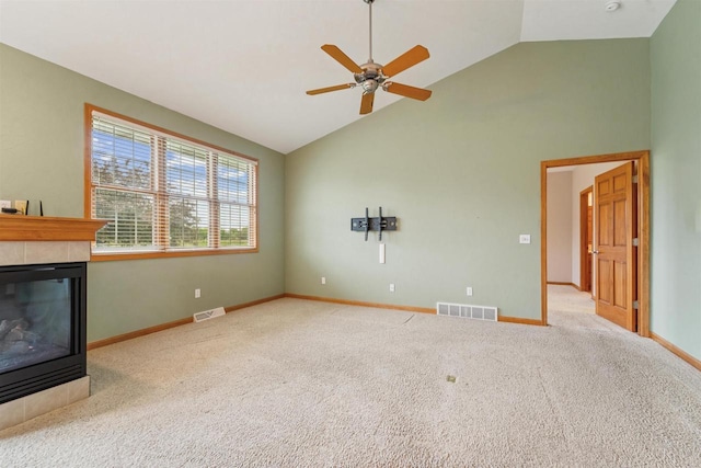 536 Coonen Dr, Combined Locks, WI 54113 - unfurnished living room featuring a tiled fireplace, carpet, ceiling fan, high vaulted ceiling, and baseboards