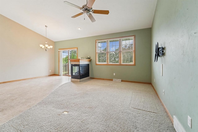 536 Coonen Dr, Combined Locks, WI 54113 - unfurnished living room with a chandelier, vaulted ceiling, a ceiling fan, baseboards, and a multi sided fireplace