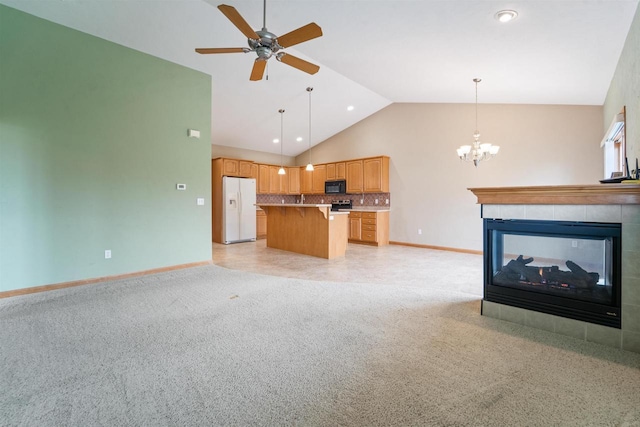 536 Coonen Dr, Combined Locks, WI 54113 - unfurnished living room featuring baseboards, ceiling fan, a chandelier, a tile fireplace, and high vaulted ceiling
