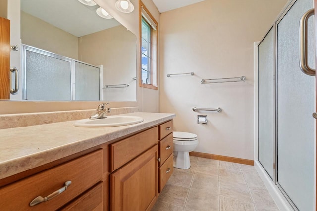 536 Coonen Dr, Combined Locks, WI 54113 - bathroom with a stall shower, vanity, toilet, baseboards, and tile patterned floors