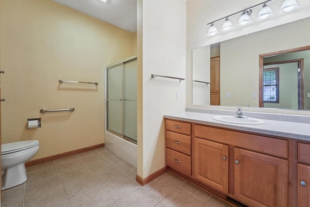 536 Coonen Dr, Combined Locks, WI 54113 - bathroom with vanity, toilet, tile patterned floors, and baseboards