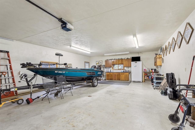 N6471 12 Corners Rd, Black Creek, WI 54106 - garage with freestanding refrigerator and a garage door opener