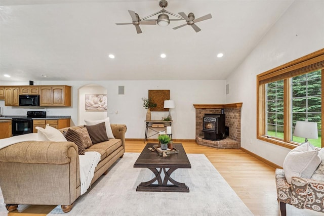N6471 12 Corners Rd, Black Creek, WI 54106 - living room featuring vaulted ceiling, a wood stove, recessed lighting, light wood-style flooring, and ceiling fan