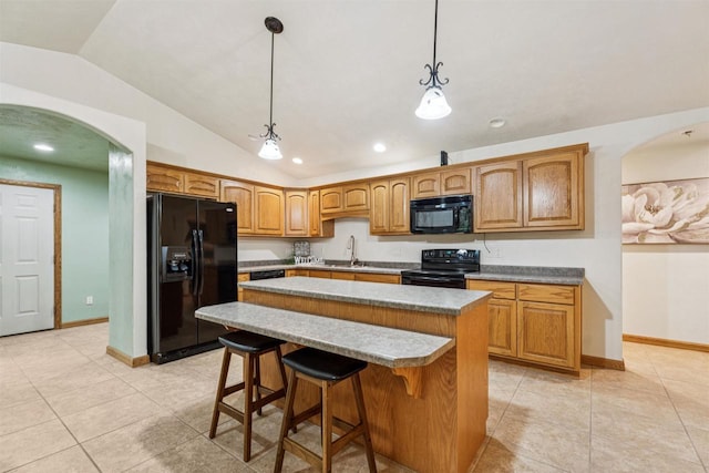 N6471 12 Corners Rd, Black Creek, WI 54106 - kitchen featuring black appliances, vaulted ceiling, a sink, a center island, and arched walkways
