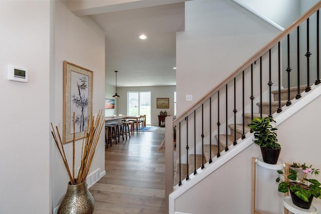 447 Crusader Pt, Waunakee, WI 53597 - staircase featuring wood finished floors and recessed lighting