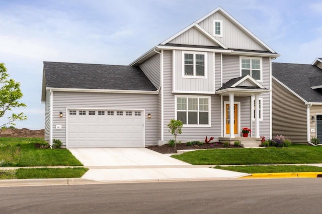 447 Crusader Pt, Waunakee, WI 53597 - view of front facade with board and batten siding, an attached garage, driveway, and a front lawn