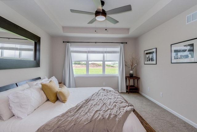 447 Crusader Pt, Waunakee, WI 53597 - carpeted bedroom with a tray ceiling, baseboards, and ceiling fan