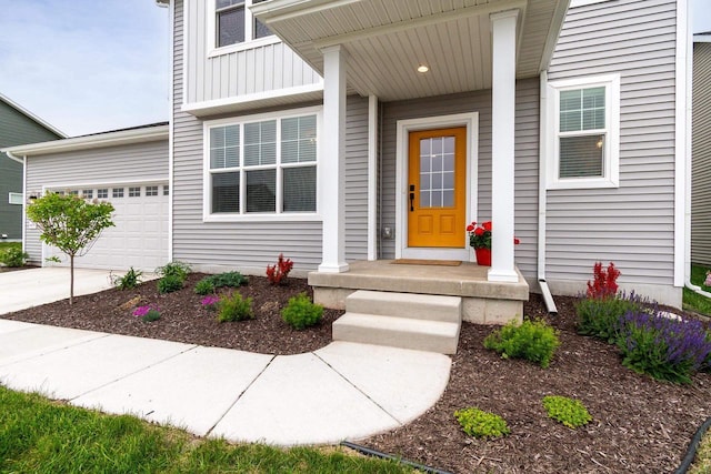 447 Crusader Pt, Waunakee, WI 53597 - entrance to property with board and batten siding, an attached garage, and concrete driveway