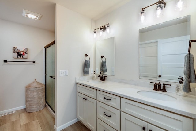447 Crusader Pt, Waunakee, WI 53597 - bathroom featuring double vanity, a stall shower, and baseboards