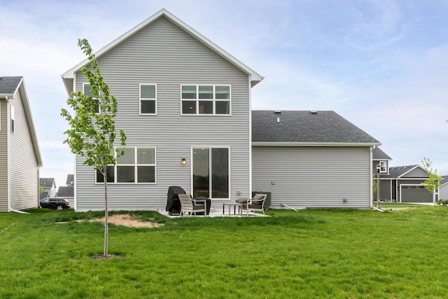 447 Crusader Pt, Waunakee, WI 53597 - back of property with a lawn, a patio, and roof with shingles