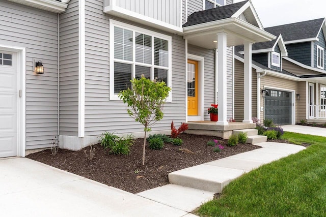 447 Crusader Pt, Waunakee, WI 53597 - doorway to property featuring concrete driveway, a shingled roof, and an attached garage