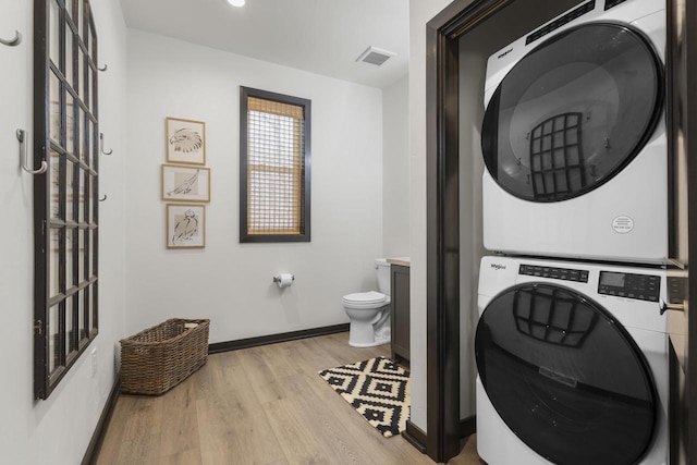 7272 Freedom Trl, Wabeno, WI 54566 - washroom with stacked washer and clothes dryer, light wood-style flooring, and baseboards