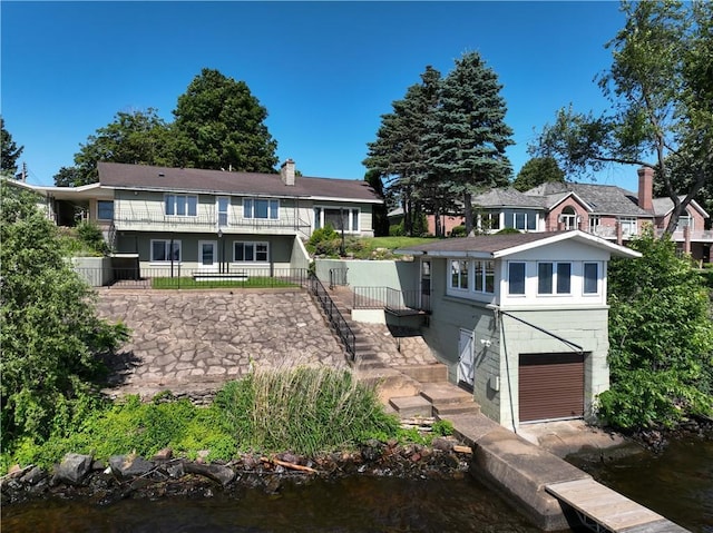 8303 163rd St, Chippewa Falls, WI 54729 - back of house featuring a chimney, stairway, and a water view