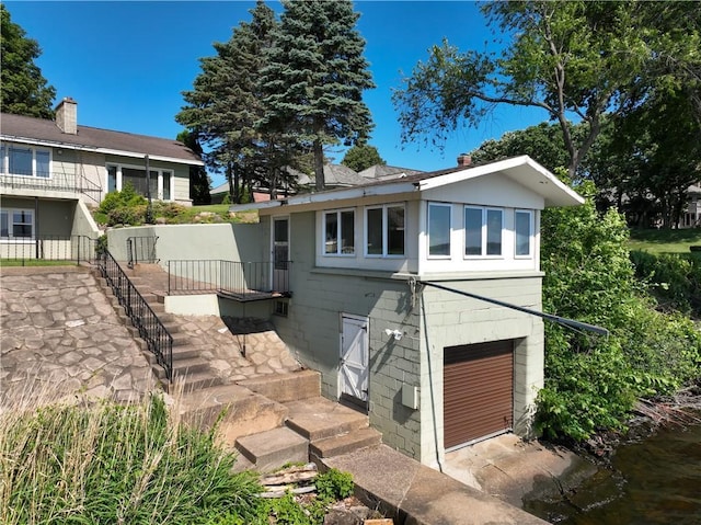 8303 163rd St, Chippewa Falls, WI 54729 - view of front of property featuring stairway and concrete block siding