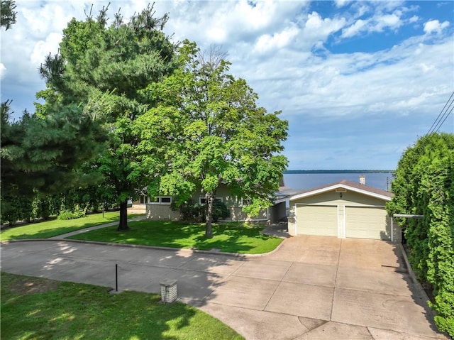 8303 163rd St, Chippewa Falls, WI 54729 - view of property hidden behind natural elements with a front lawn, driveway, and an attached garage