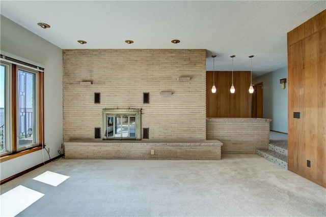 8303 163rd St, Chippewa Falls, WI 54729 - unfurnished living room with carpet, brick wall, wood walls, and a brick fireplace