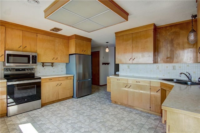 8303 163rd St, Chippewa Falls, WI 54729 - kitchen featuring stainless steel appliances, tasteful backsplash, light countertops, and hanging light fixtures