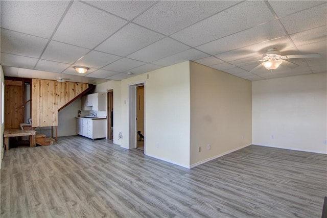 8303 163rd St, Chippewa Falls, WI 54729 - unfurnished living room with a drop ceiling, light wood-style flooring, and ceiling fan