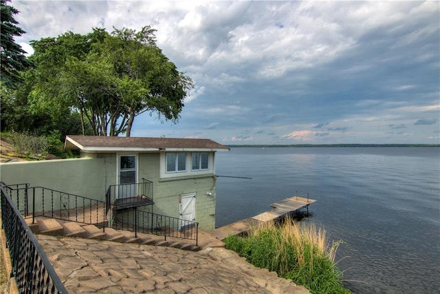 8303 163rd St, Chippewa Falls, WI 54729 - view of front of home featuring a water view, a dock, and concrete block siding