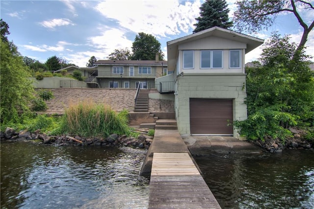 8303 163rd St, Chippewa Falls, WI 54729 - rear view of house with stairway, a water view, and a garage