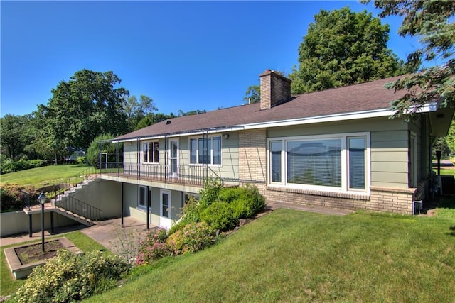 8303 163rd St, Chippewa Falls, WI 54729 - back of house featuring brick siding, stairs, a chimney, a yard, and a patio
