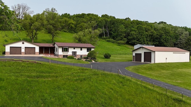 N3661 Peters Rd, La Crosse, WI 54601 - view of front of house featuring a detached garage, an outbuilding, and a wooded view