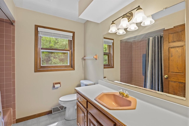 S69W32641 Westgate Dr, Mukwonago, WI 53149 - full bath with toilet, healthy amount of natural light, vanity, and baseboards