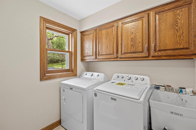 S69W32641 Westgate Dr, Mukwonago, WI 53149 - laundry room featuring washing machine and dryer, cabinet space, and baseboards