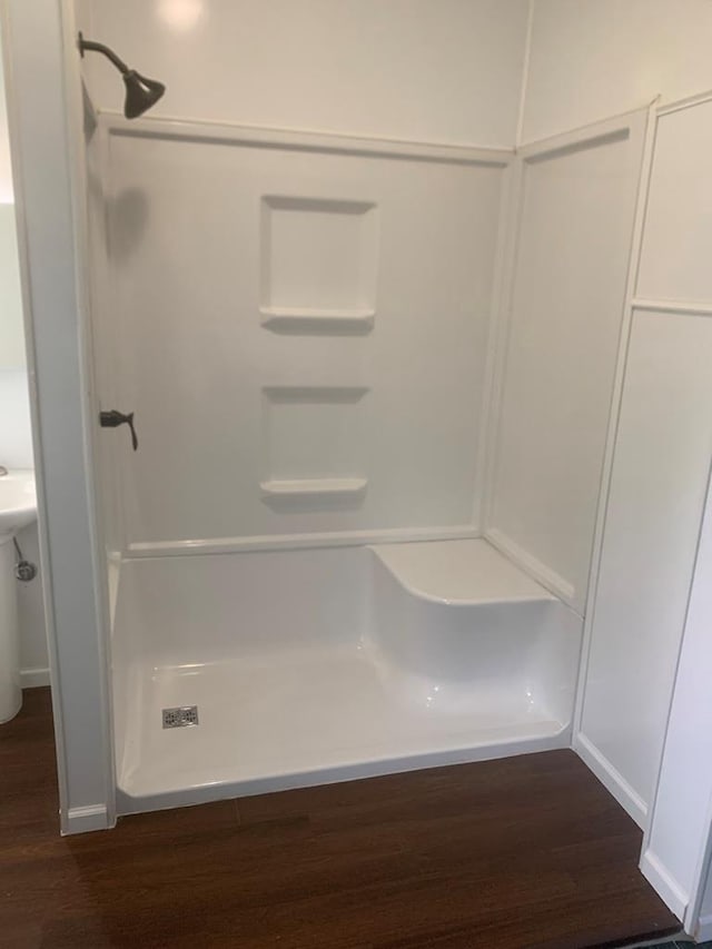 2811 Willow Dr, Plover, WI 54467 - full bathroom with wood finished floors, a shower stall, and baseboards