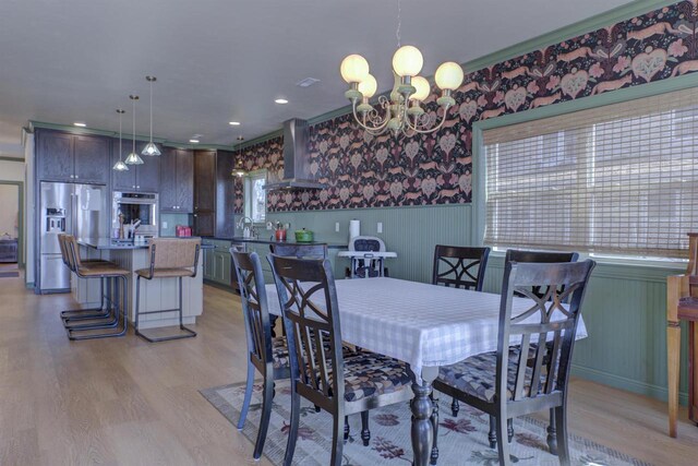 W7133 Firelane 2, Menasha, WI 54952 - dining area featuring light wood finished floors, wainscoting, a chandelier, plenty of natural light, and recessed lighting