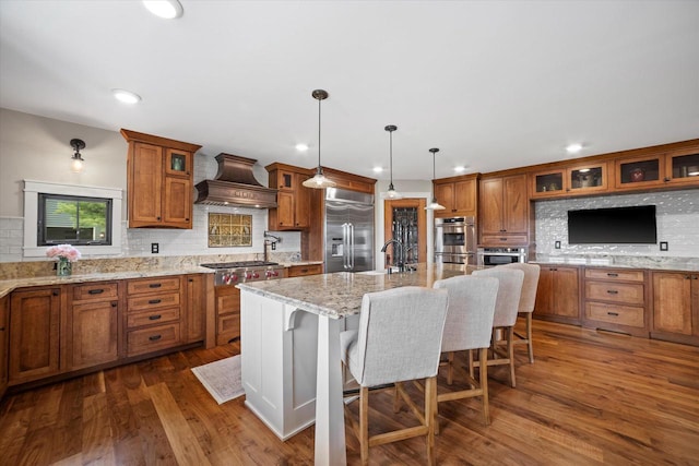 S28W31464 County Road De, Waukesha, WI 53189 - kitchen featuring stainless steel appliances, wall chimney range hood, brown cabinets, backsplash, and recessed lighting