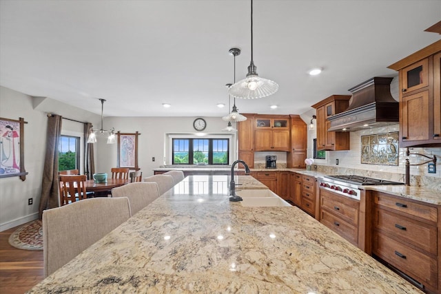 S28W31464 County Road De, Waukesha, WI 53189 - kitchen with brown cabinets, stainless steel gas cooktop, custom range hood, plenty of natural light, and recessed lighting