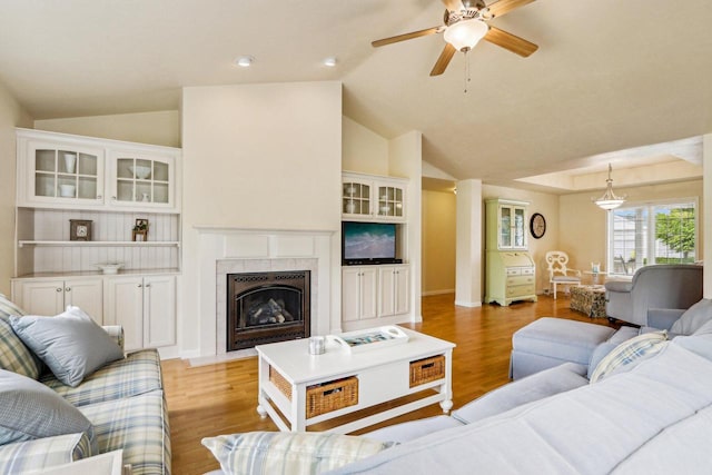 522 Otto Way, Elkhart Lake, WI 53020 - living area featuring lofted ceiling, light wood finished floors, a fireplace with flush hearth, ceiling fan, and baseboards
