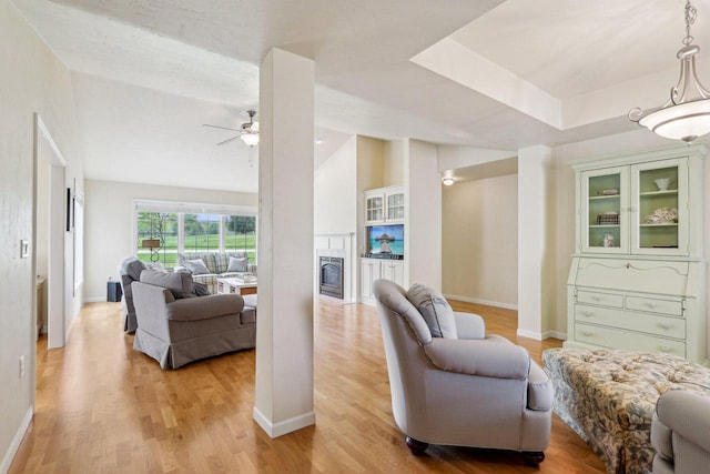 522 Otto Way, Elkhart Lake, WI 53020 - living area featuring a ceiling fan, light wood finished floors, baseboards, and a fireplace