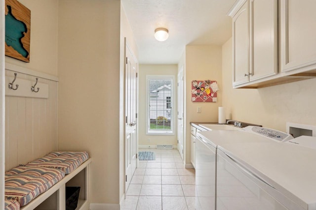 522 Otto Way, Elkhart Lake, WI 53020 - laundry room featuring cabinet space, washing machine and dryer, light tile patterned flooring, and baseboards