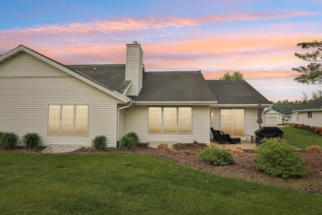 522 Otto Way, Elkhart Lake, WI 53020 - rear view of property with a patio, a lawn, a chimney, and roof with shingles