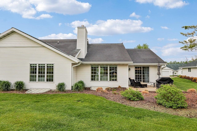 522 Otto Way, Elkhart Lake, WI 53020 - rear view of property with a patio, a lawn, and a chimney