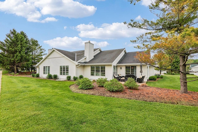 522 Otto Way, Elkhart Lake, WI 53020 - rear view of property featuring a yard, a chimney, and a patio