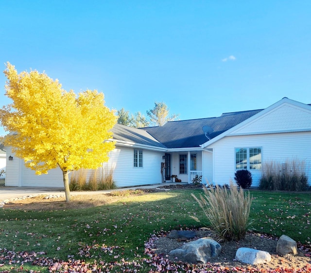 522 Otto Way, Elkhart Lake, WI 53020 - ranch-style house with a front yard, covered porch, and an attached garage