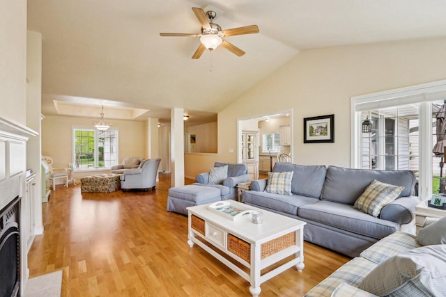 522 Otto Way, Elkhart Lake, WI 53020 - living room featuring a ceiling fan, light wood finished floors, lofted ceiling, and a fireplace with flush hearth