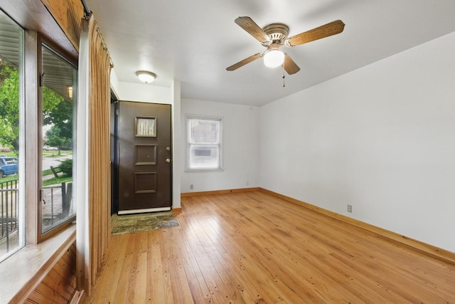 2507 S 94th St, West Allis, WI 53227 - foyer with light wood-style flooring, ceiling fan, and baseboards