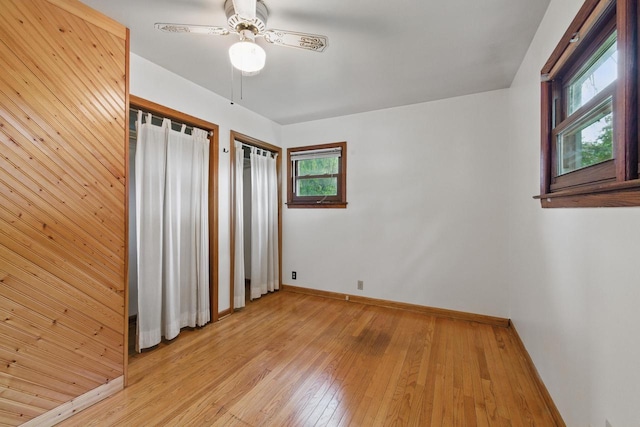 2507 S 94th St, West Allis, WI 53227 - unfurnished bedroom with light wood-style floors, baseboards, multiple closets, and ceiling fan