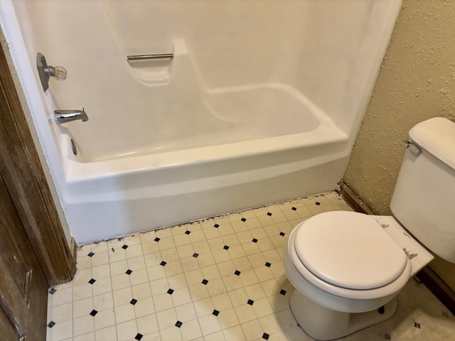 788 S River Rd Unit 7, West Bend, WI 53095 - full bath featuring toilet,  shower combination, tile patterned flooring, and a textured wall
