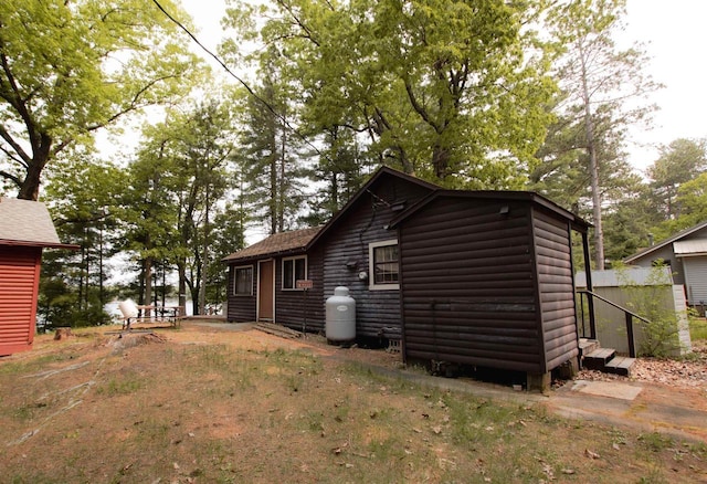 W5522 S Round Lake Rd, Wild Rose, WI 54984 - back of property with faux log siding